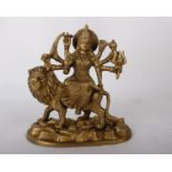 An Indian brass / bronze metal figurine of The God Deity Durga. Seated on a lion with eight arms