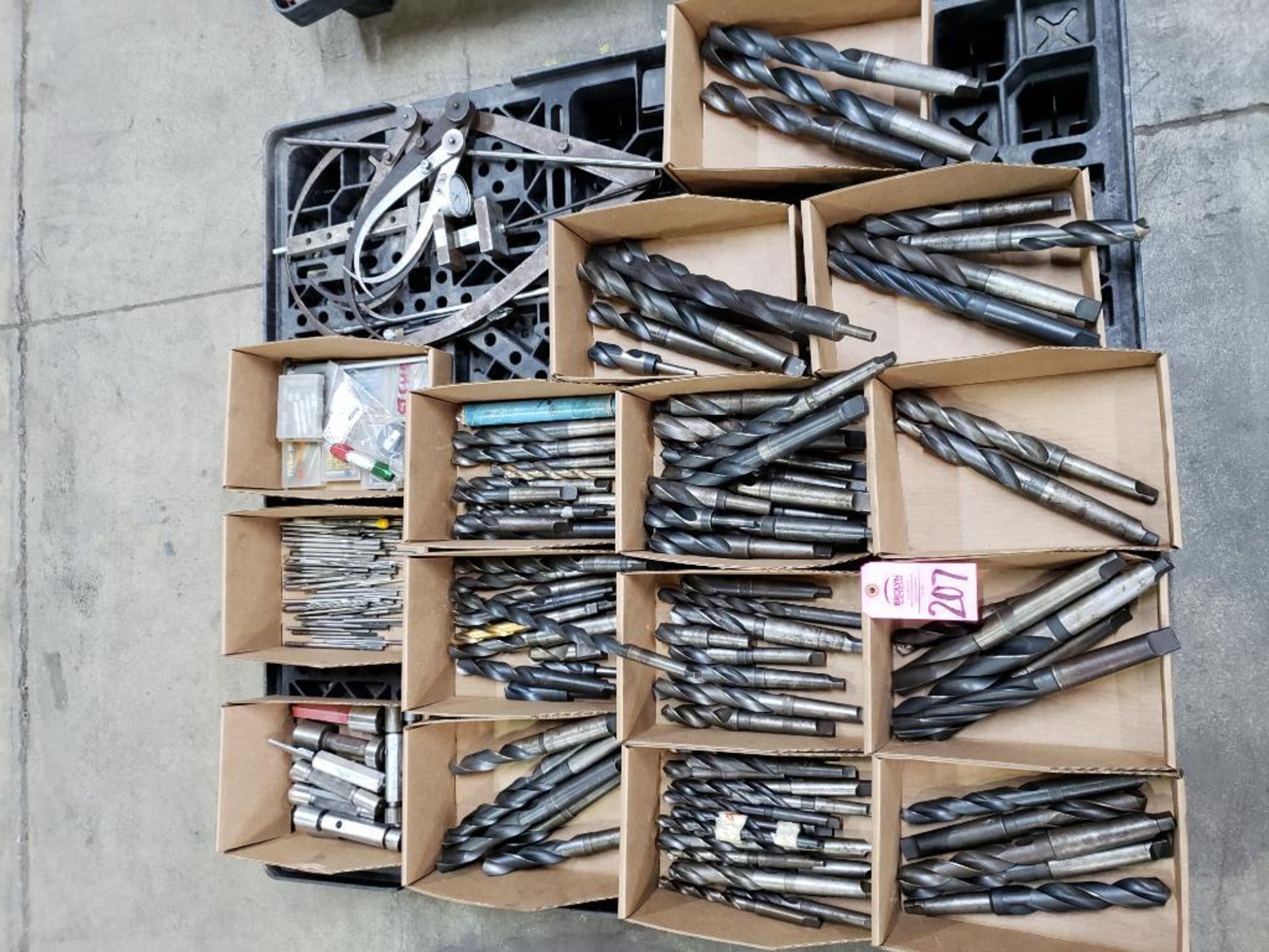 Pallet with large assortment of drills and other assorted consumables.