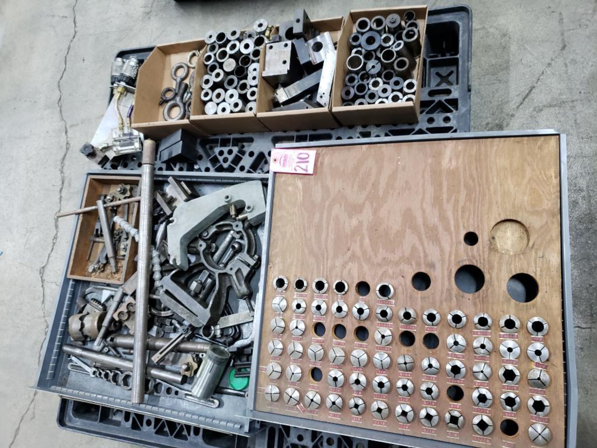 Pallet with large assortment of collets and other machine tools and fixtures.