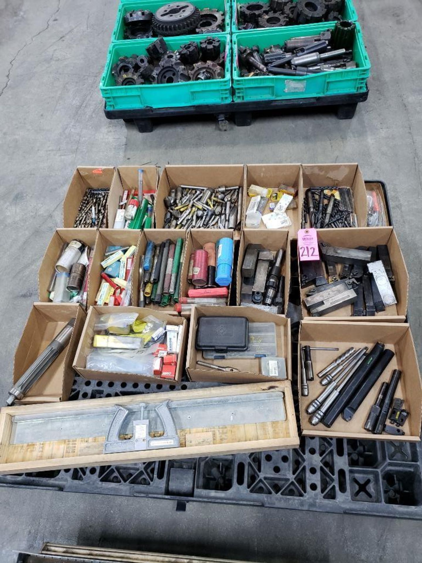 Pallet with large assortment of end mills, tooling, and other consumables.