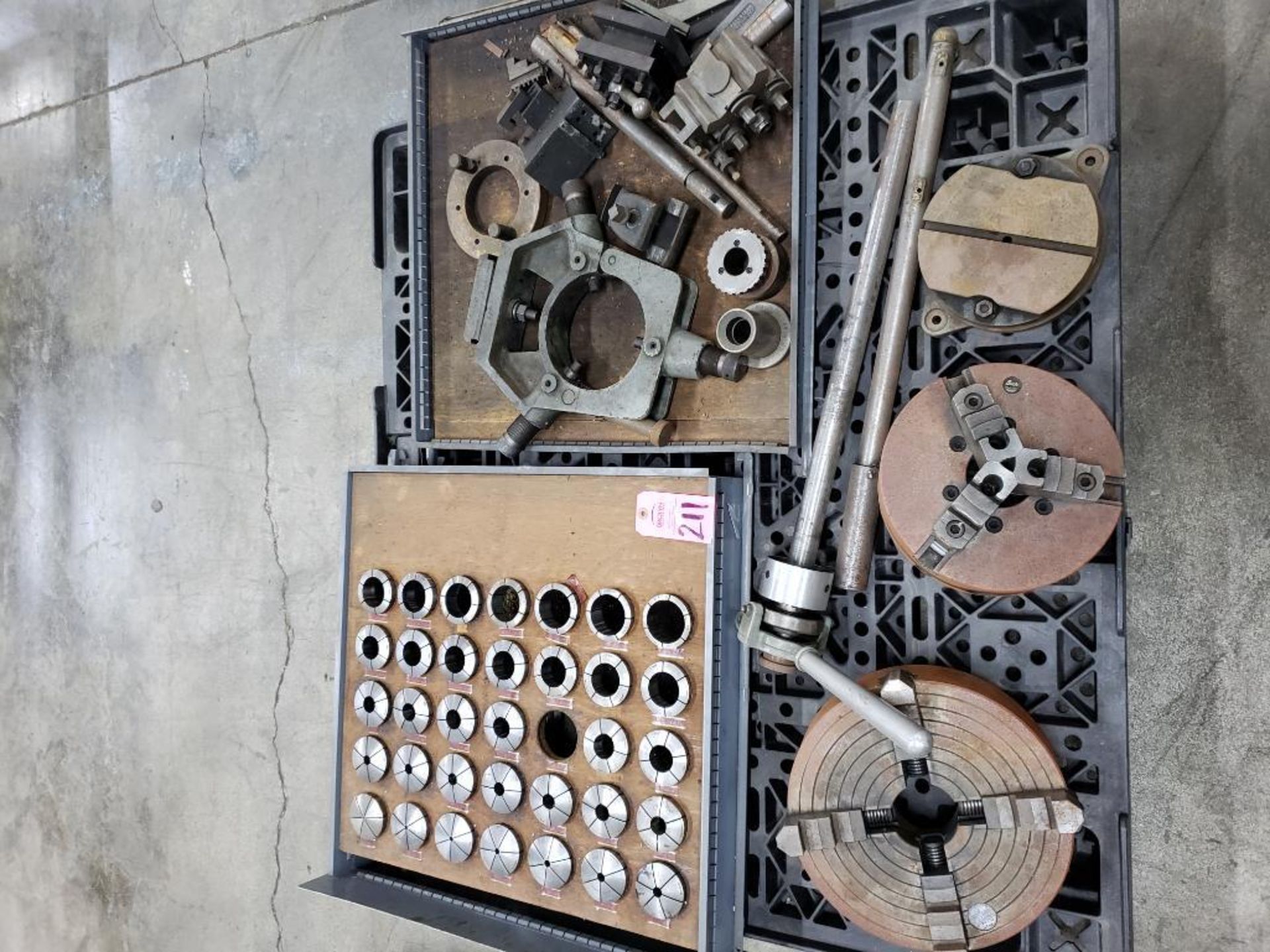 Pallet with large assortment of collets, chucks, and other machine tools and fixtures.