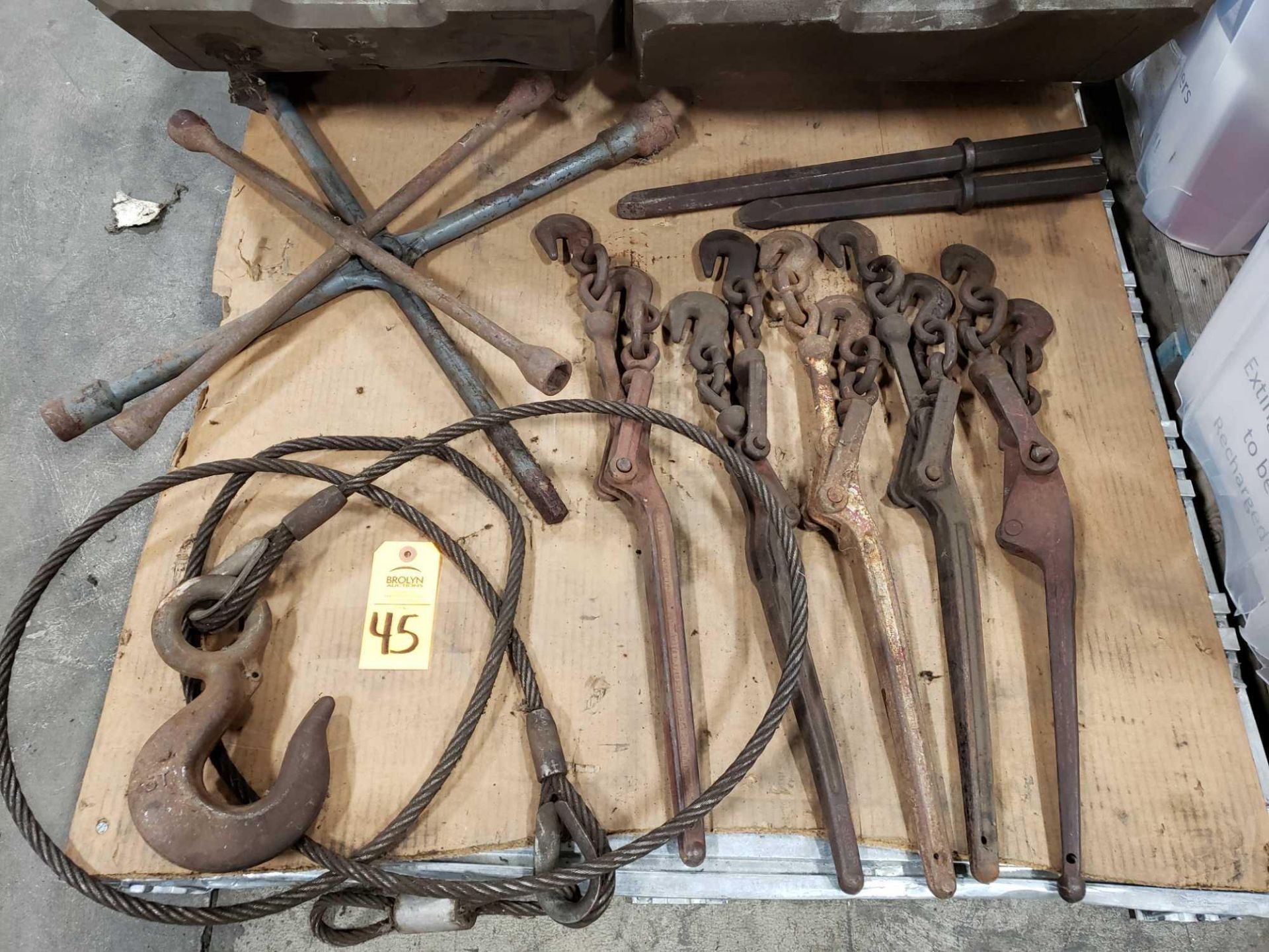 Assorted chain binders, 4 way lug wrenches, and chisels.