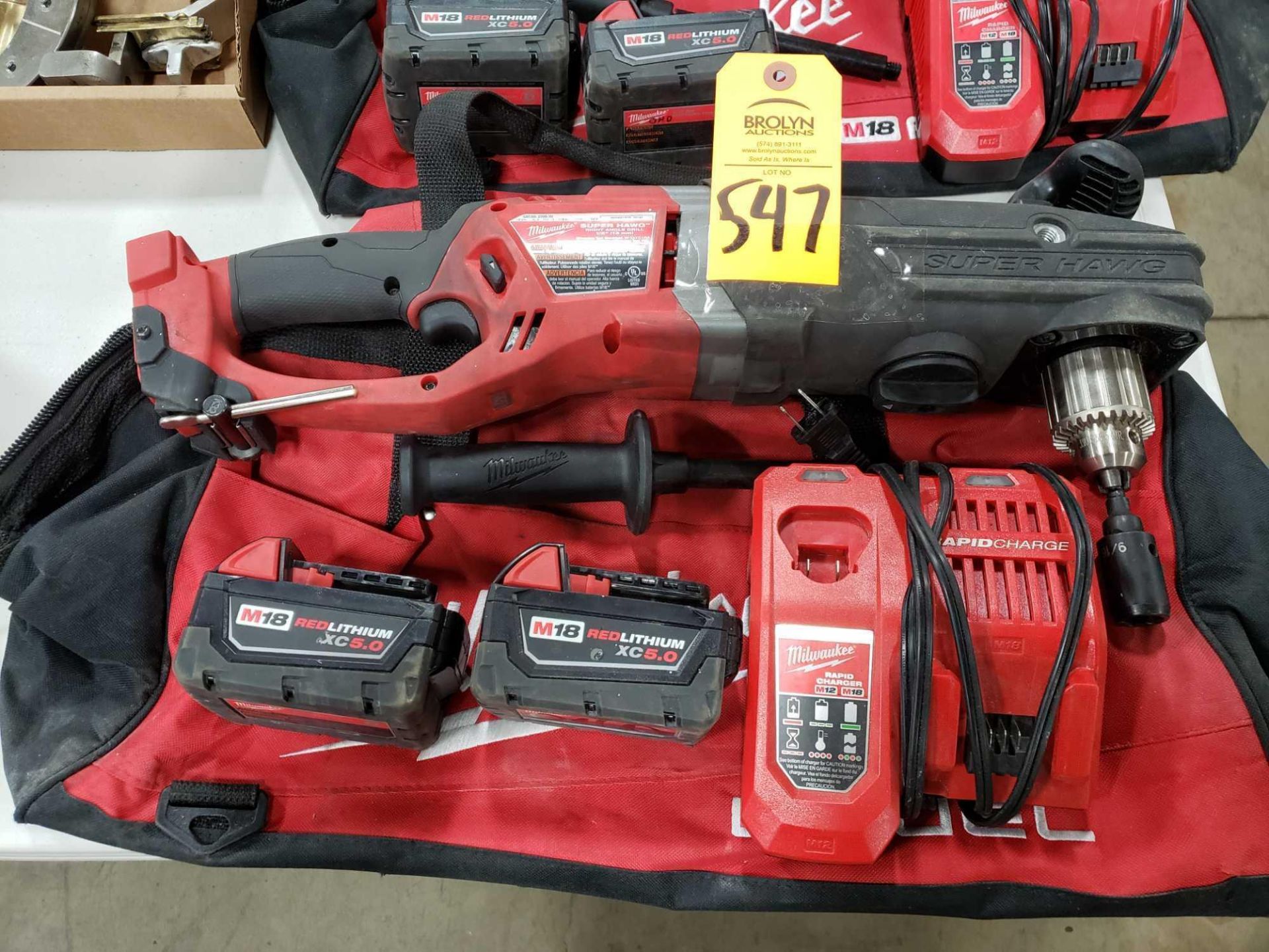18v Milwaukee 1/2" super hawg right angle cordless drill with 2 batteries, charger, and storage bag.