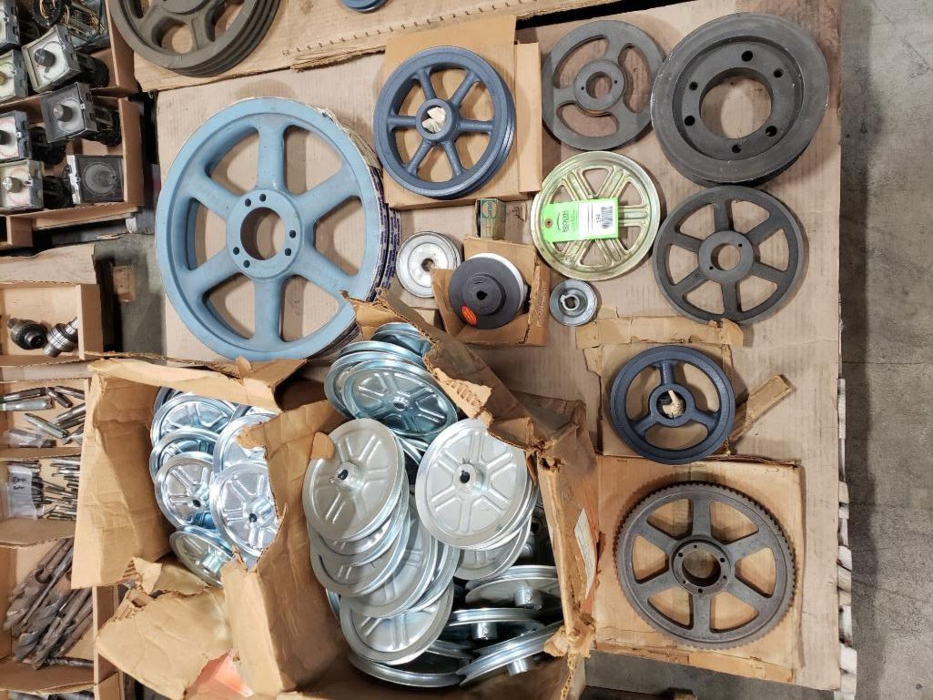 Pallet of assorted bushings, sprockets, pulleys, etc. Most are new old stock.