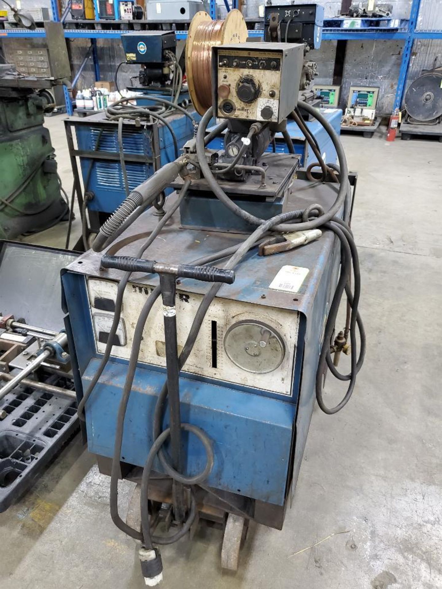 Miller CP-250TS welder with style He-6 wire feed.