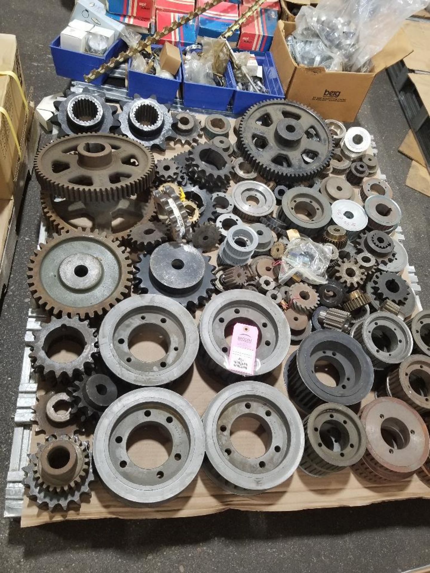 Pallet of assorted gears, pulleys, and bushings. Most new old stock.