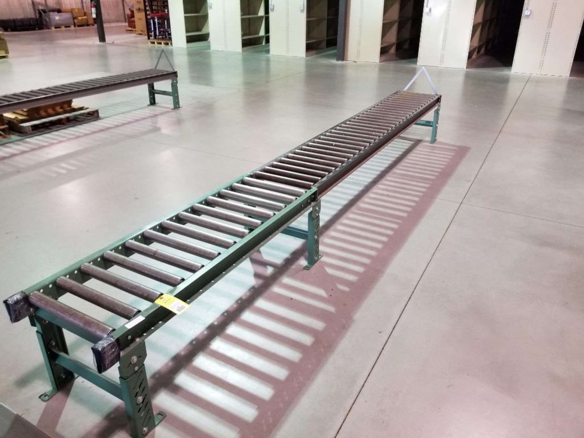 15ft roller conveyor section. 20in wide by 20in tall. (legs are adjustable to change height)