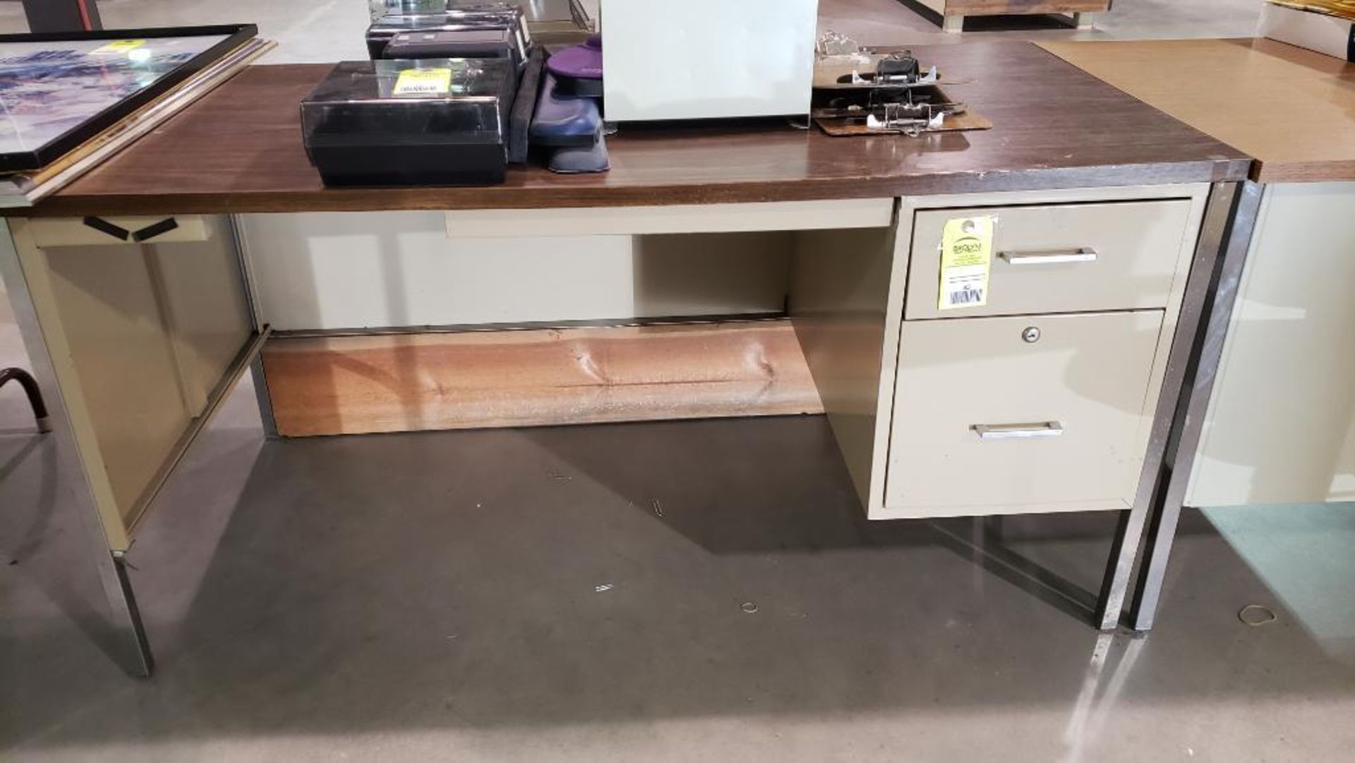 Metal office desk with wood laminate top.