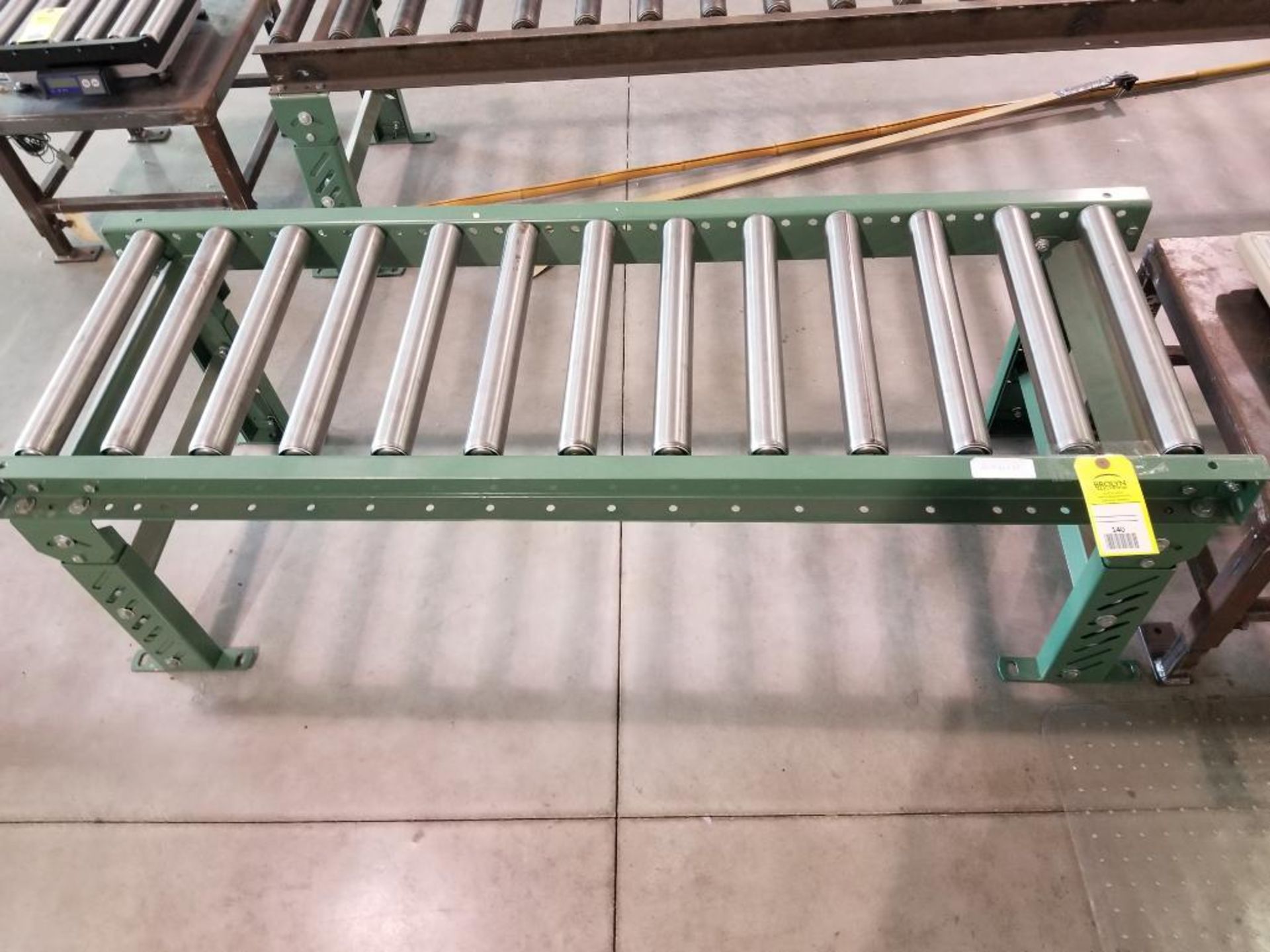 5ft roller conveyor section. 20in wide by 20in tall. (legs are adjustable to change height)