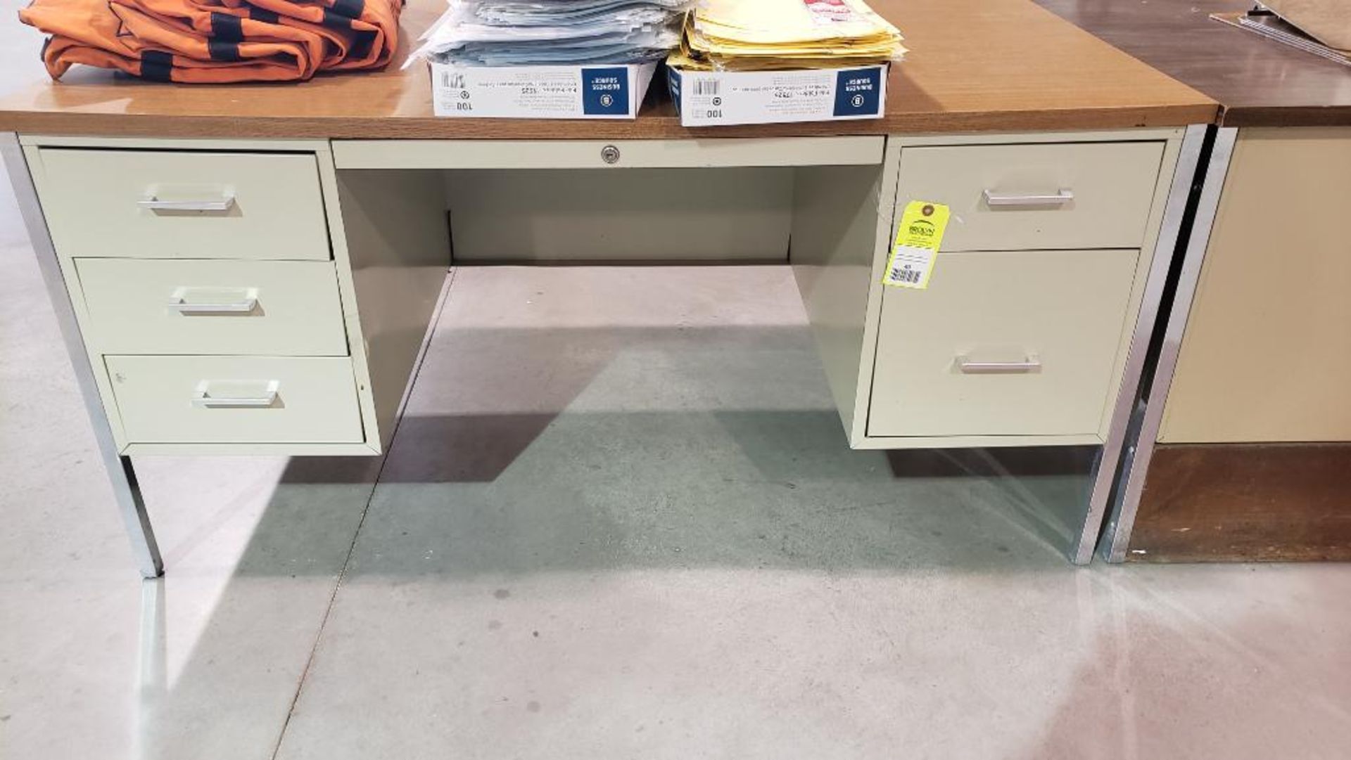 Metal office desk with wood laminate top.