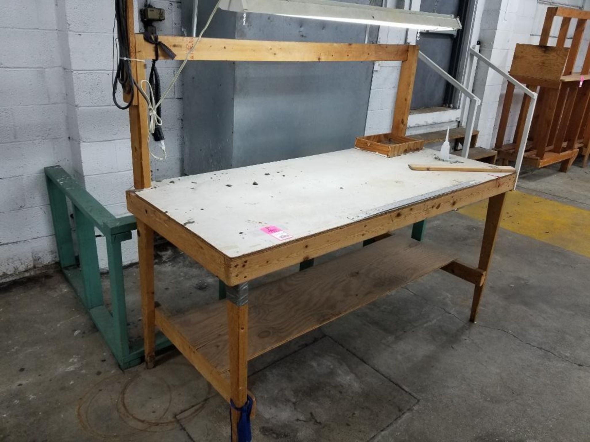 Wooden work bench with overhead light.