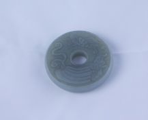 Chinese Mutton Jade Disc Pendant, Decorated with panels of bats and lotus flowers, 5.5cm diameter