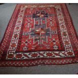 Koliaei Rug, Decorated with allover geometric medallions and motifs on a red ground, 210cm x 160cm