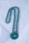 Spinach Jade Bead Necklace, with a fixed jade circular pendant, approximately 36cm long, (2)