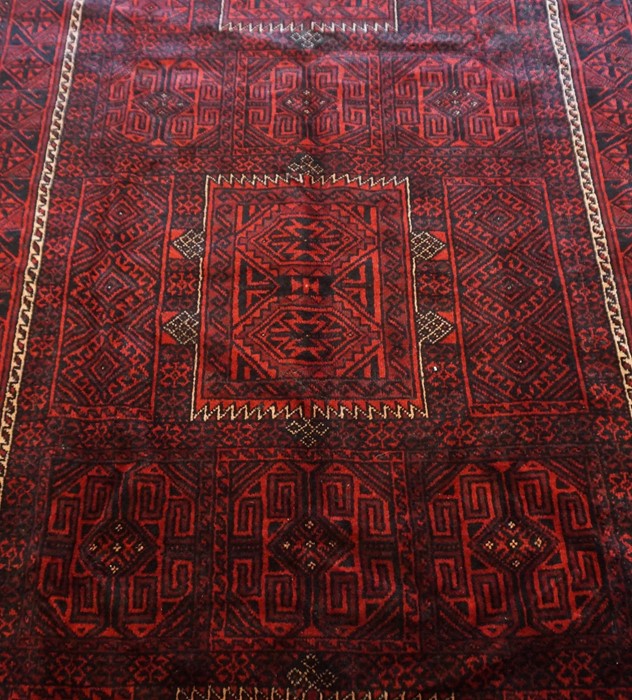 Blouch Rug, Decorated with allover geometric medallions on a red ground, 270cm x 150cm - Image 2 of 2