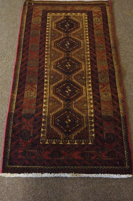 Bluch Prayer Mat / Rug, Decorated with five geometric medallions on a red ground, 122cm x 66cm