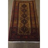 Bluch Prayer Mat / Rug, Decorated with five geometric medallions on a red ground, 122cm x 66cm