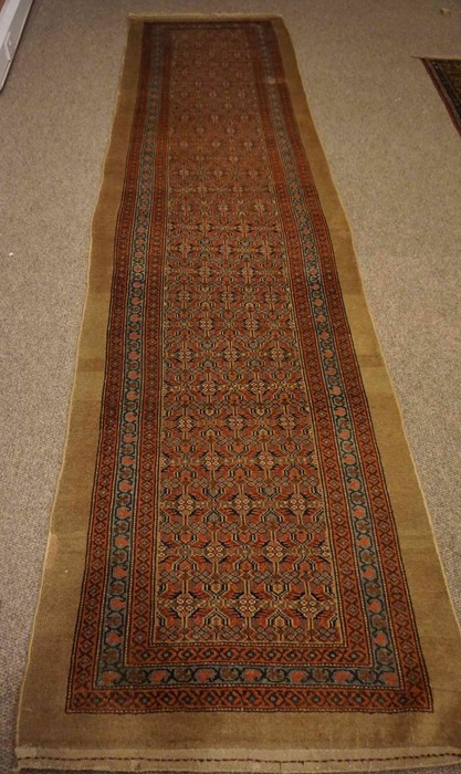 North West Persian Runner, Decorated with allover floral panels on a red and blue ground, with beige