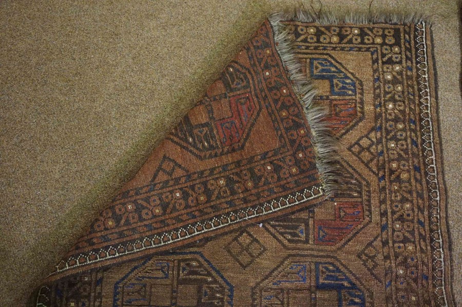 Persian Bluch Rug, Decorated with eight geometric medallions on a brown ground, 119cm x 94cm - Image 4 of 4