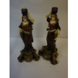 Pair of Majolica Candlesticks, Modelled as a female holding a torchere, decorated with masks, 45cm
