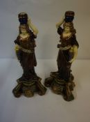 Pair of Majolica Candlesticks, Modelled as a female holding a torchere, decorated with masks, 45cm