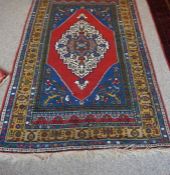 Tubbinar Rug, Decorated with a large geometric medallion on a red, blue and beige ground, 190cm x