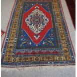 Tubbinar Rug, Decorated with a large geometric medallion on a red, blue and beige ground, 190cm x