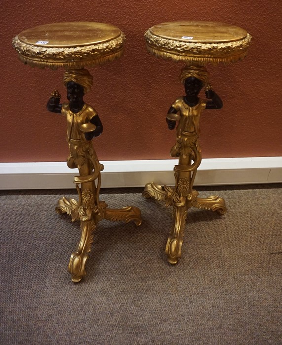 Pair of Gilded Blackamoor Torchere, (20th century) Raised on carved tripod supports, 95cm high, (2)