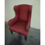 Upholstered Wing Armchair, raised on turned front legs with castors, 113cm high