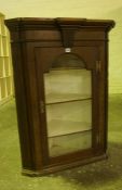 Oak Corner Cabinet, circa 19th century, Having a glazed door enclosing a shelved interior, 103cm