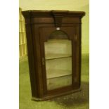 Oak Corner Cabinet, circa 19th century, Having a glazed door enclosing a shelved interior, 103cm