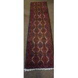 Bluch Runner, Decorated with allover geometric motifs on a red ground, 190cm x 50cm