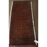 Turkman Prayer Mat / Rug, Decorated with allover geometric medallions on a red ground, 100cm x 48cm