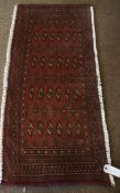 Turkman Prayer Mat / Rug, Decorated with allover geometric medallions on a red ground, 100cm x 48cm