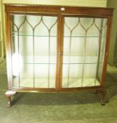 Mahogany Display Cabinet, Having two glazed doors enclosing glass shelves, raised on ball and claw