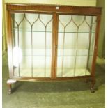 Mahogany Display Cabinet, Having two glazed doors enclosing glass shelves, raised on ball and claw