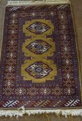 Turkman Prayer Mat, Decorated with three central geometric medallions on a red ground, 100cm x 65cm