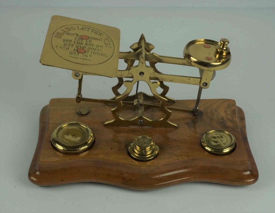 Set of Brass Postal Scales, with weights, raised on a wooden serpentine shaped base