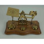 Set of Brass Postal Scales, with weights, raised on a wooden serpentine shaped base