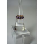 18ct Gold Amethyst Ring, Set with three graduated amethyst,s, stamped 18, overall 5.2 grams, ring