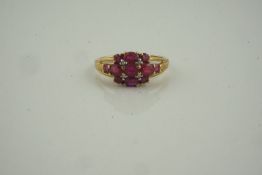 9ct Gold Gem Set and Diamond Ring, set with graduated ruby coloured stones, flanked with diamond