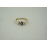 9ct Gold Gem Set and Diamond Ring, Having a single gem stone, flanked with diamond chips to the