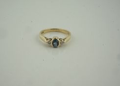 9ct Gold Gem Set and Diamond Ring, Having a single gem stone, flanked with diamond chips to the