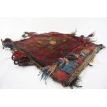 Two Persian Hand Knotted Saddle Bags, Decorated with geometric panels on red grounds, 45cm x 41cm,