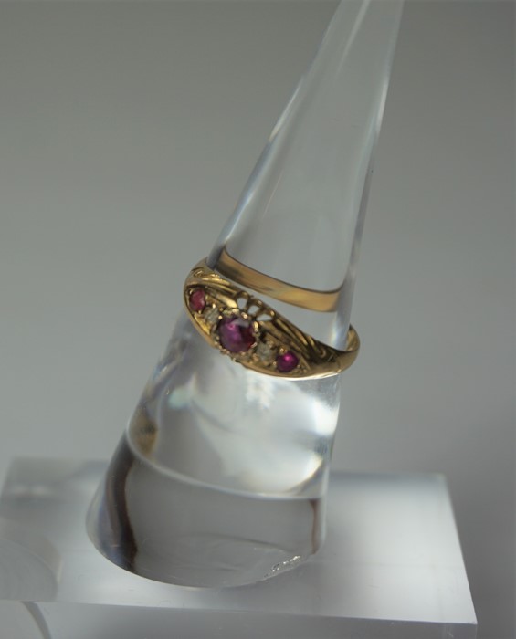 18ct Gold Ruby and Diamond Ring, Set with a ruby to the centre, flanked with smaller rubies and