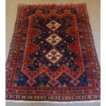 Afshar Rug, Decorated with three central geometric medallions on a red ground, 215cm x 160cm