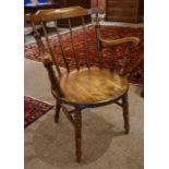 Stained Wood Smokers Chair, circa late 19th / early 20th century, Having a spindle back rest, raised