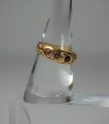 18ct Gold Ruby and Diamond Ring, Set with three small rubies, interspersed with two small