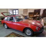 1977 MGB GT 1.8L. Red with black vinyl, showing 20,400 miles unchecked. Offered for restoration.