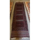 Afghan Runner, Decorated with five panels of geometric motifs on a red ground, 250cm x 63cm